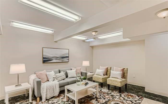 a room with a couch and chairs