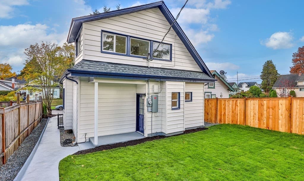 a house with a fence and grass yard