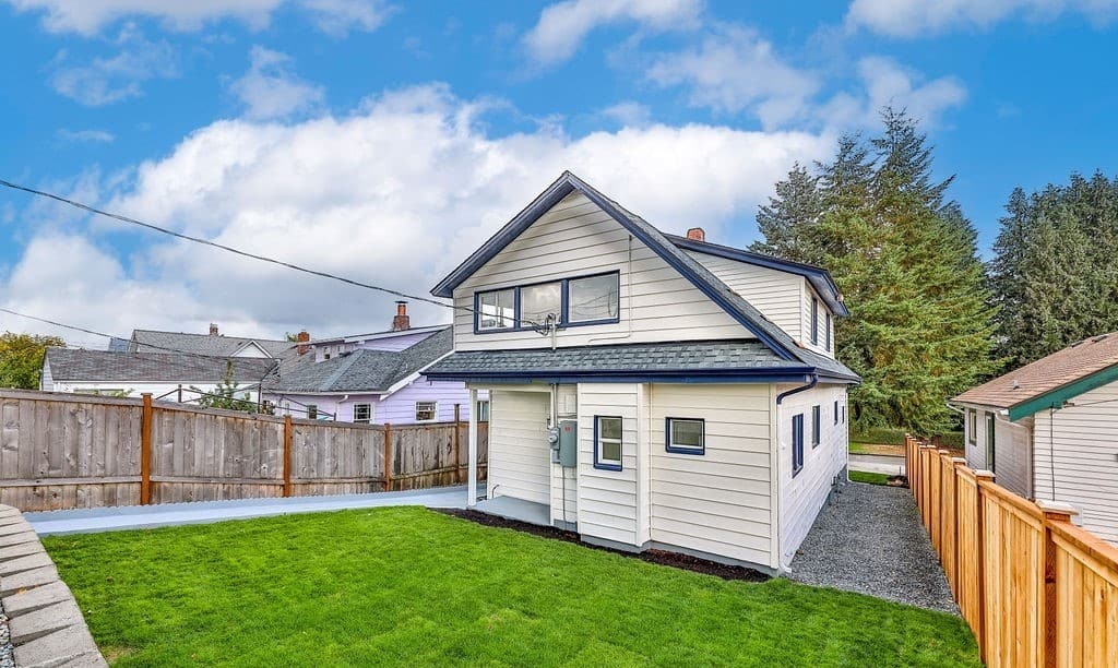 a house with a lawn and a fence