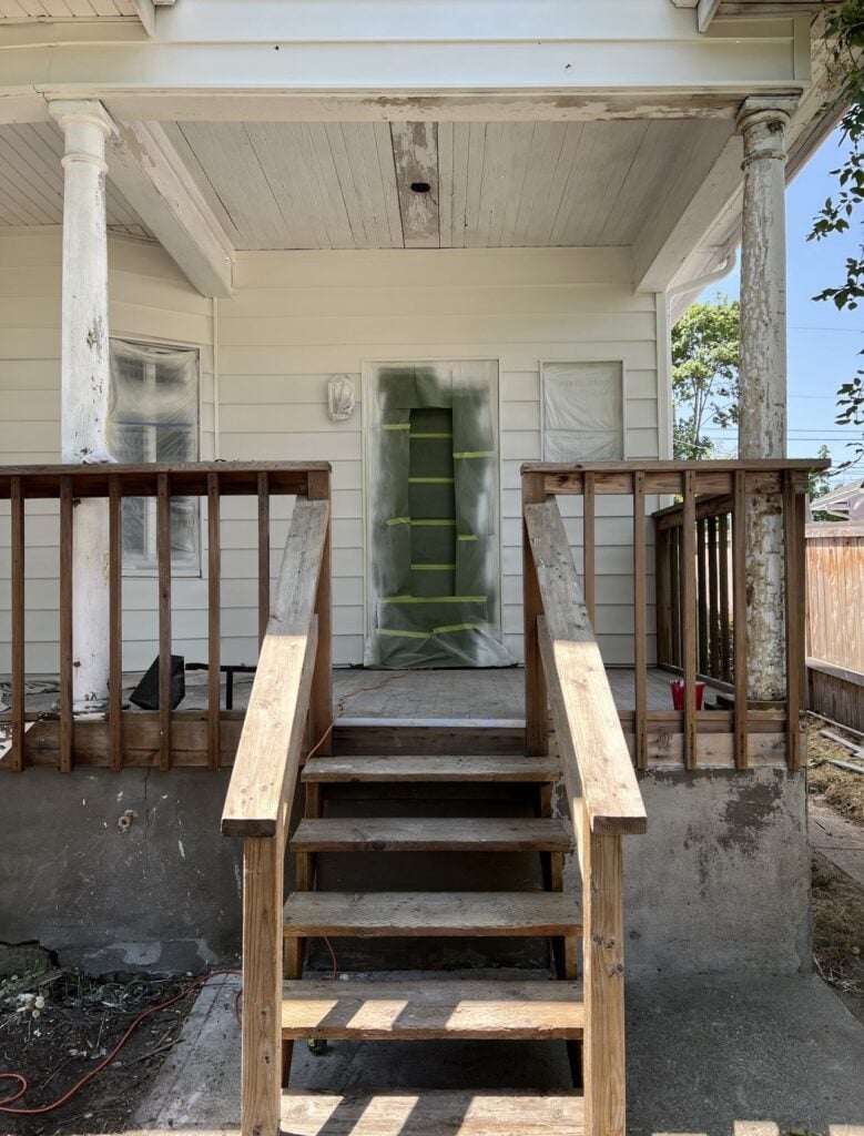 a porch with stairs and railings