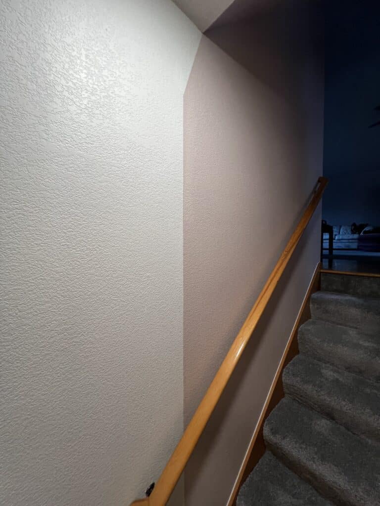 a staircase and a light on the wall