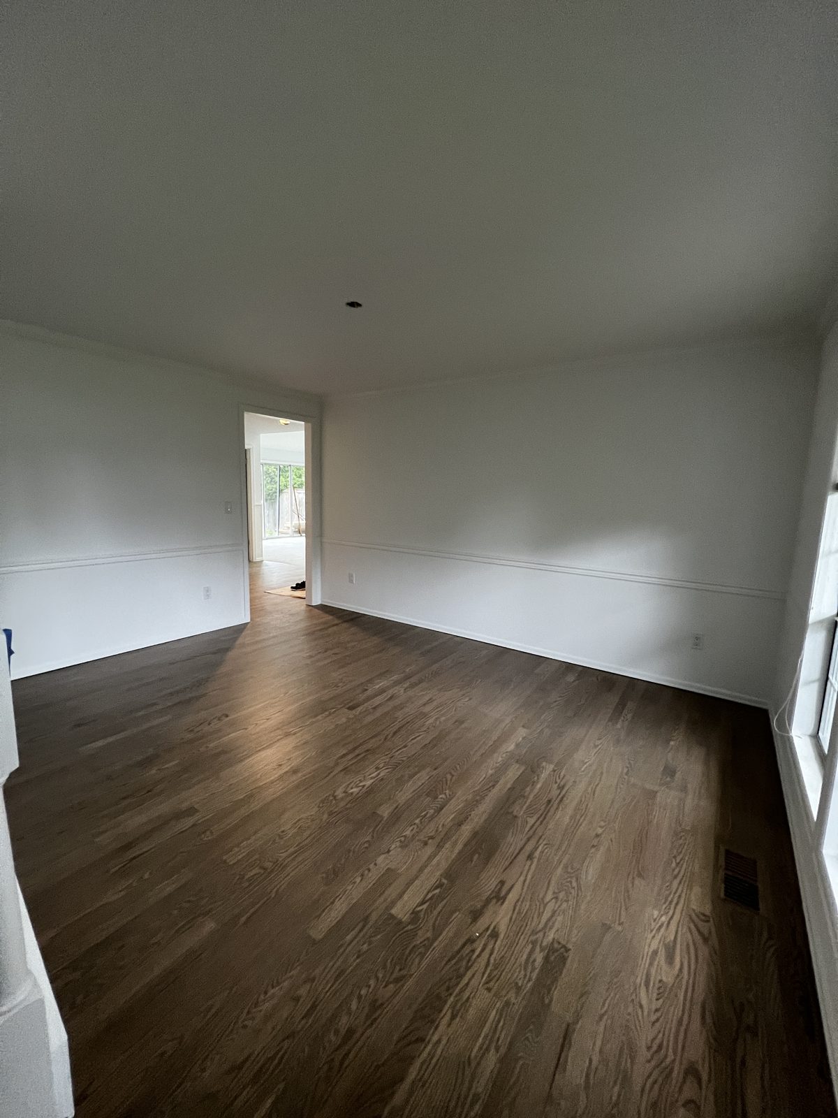 Freshly painted room with dark hardwood floors in Mill Creek