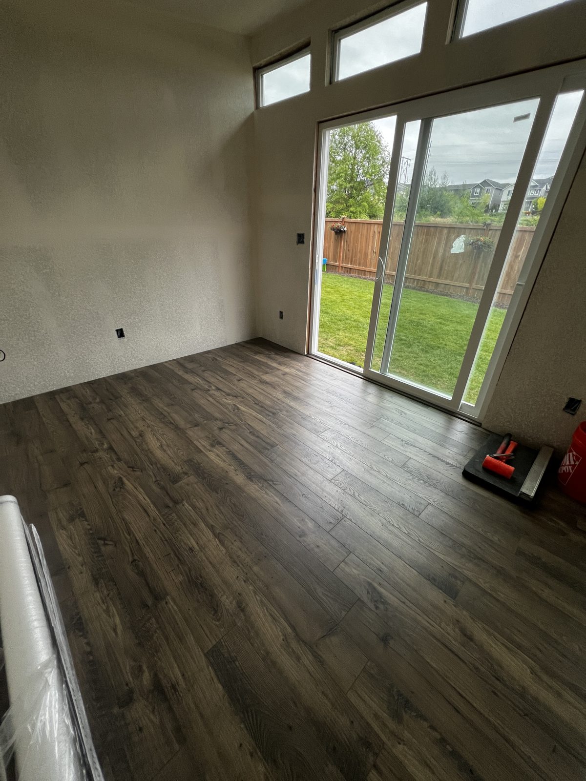 New plank flooring inside the Everett studio with a sliding glass door