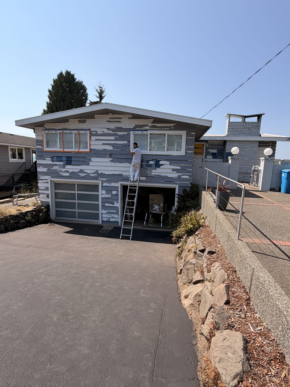 Edmonds house exterior scraped and spot-primed before painting