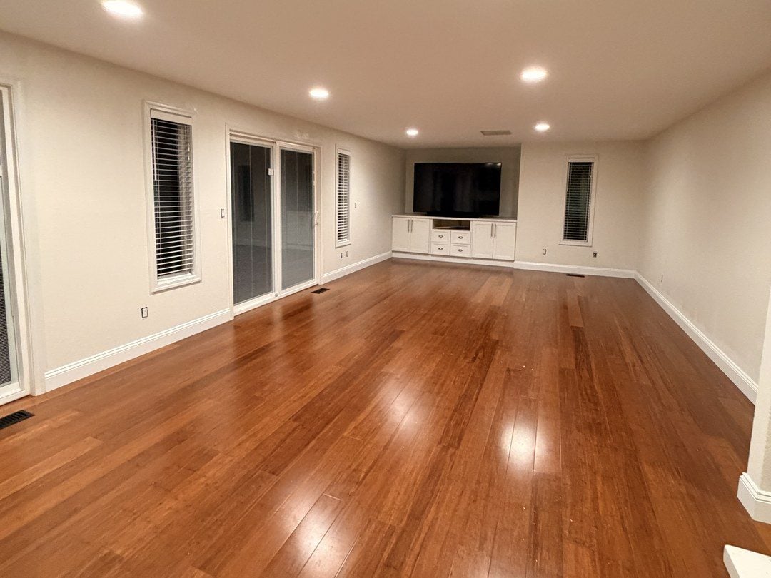 Open living space in Mill Creek with freshly painted walls and white baseboards