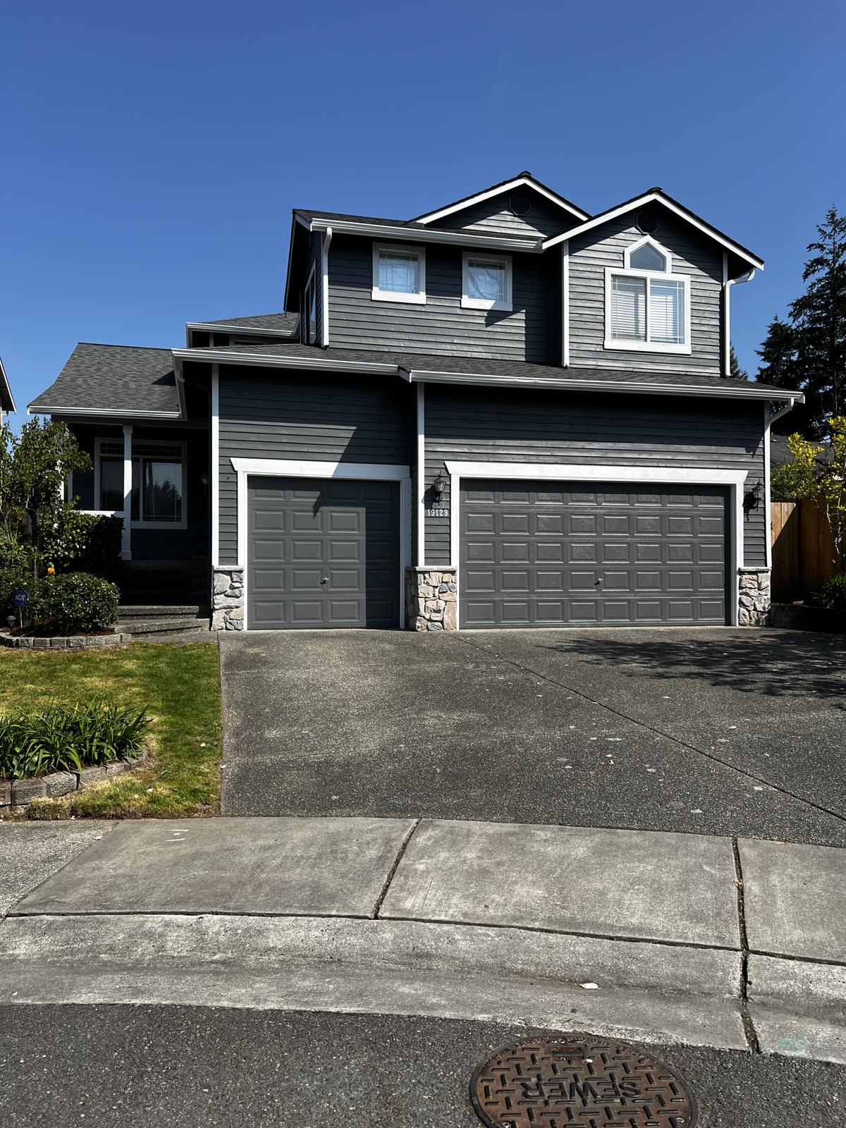 The same home finished in charcoal gray with crisp white trim