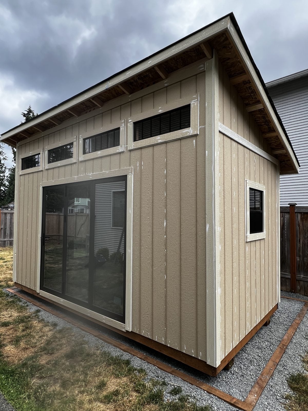 Backyard studio in plain builder tan before painting