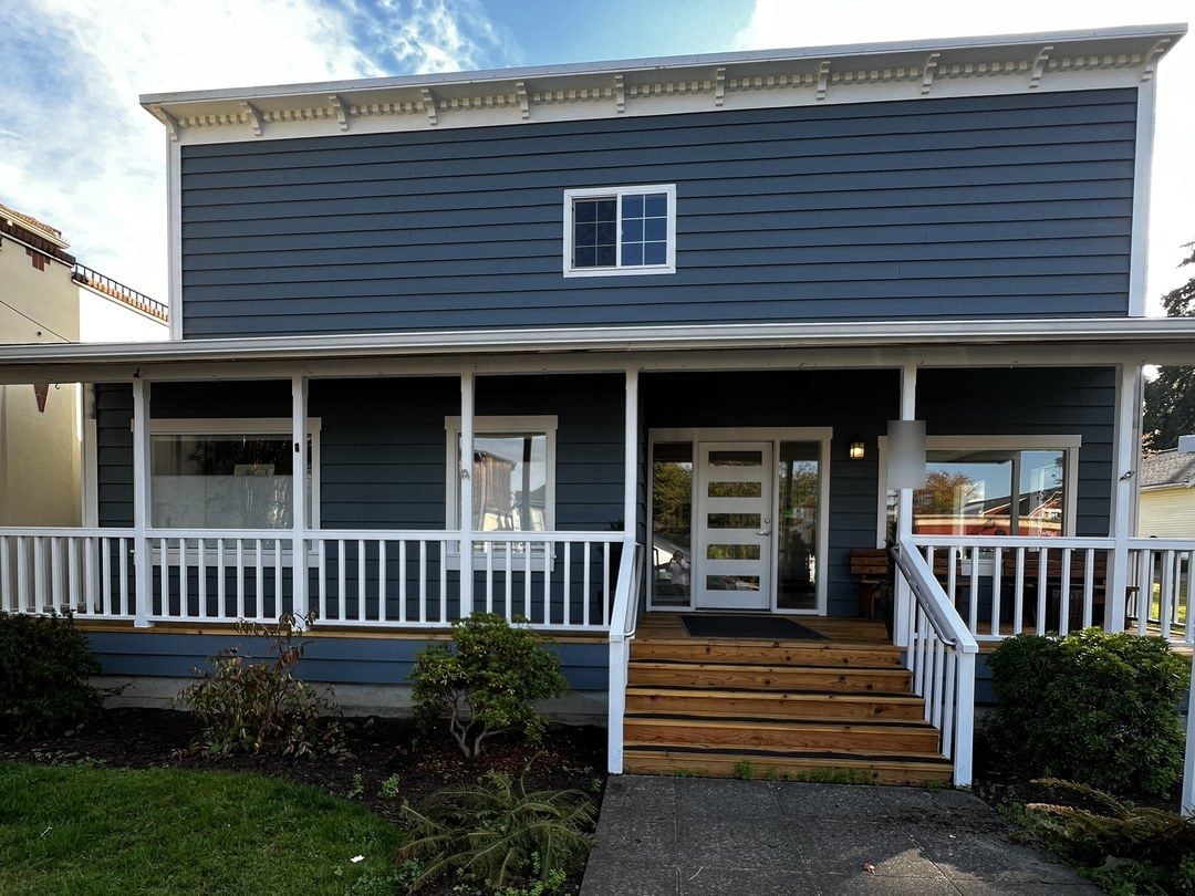 Commercial building on Whidbey Island repainted blue with a white porch and railings