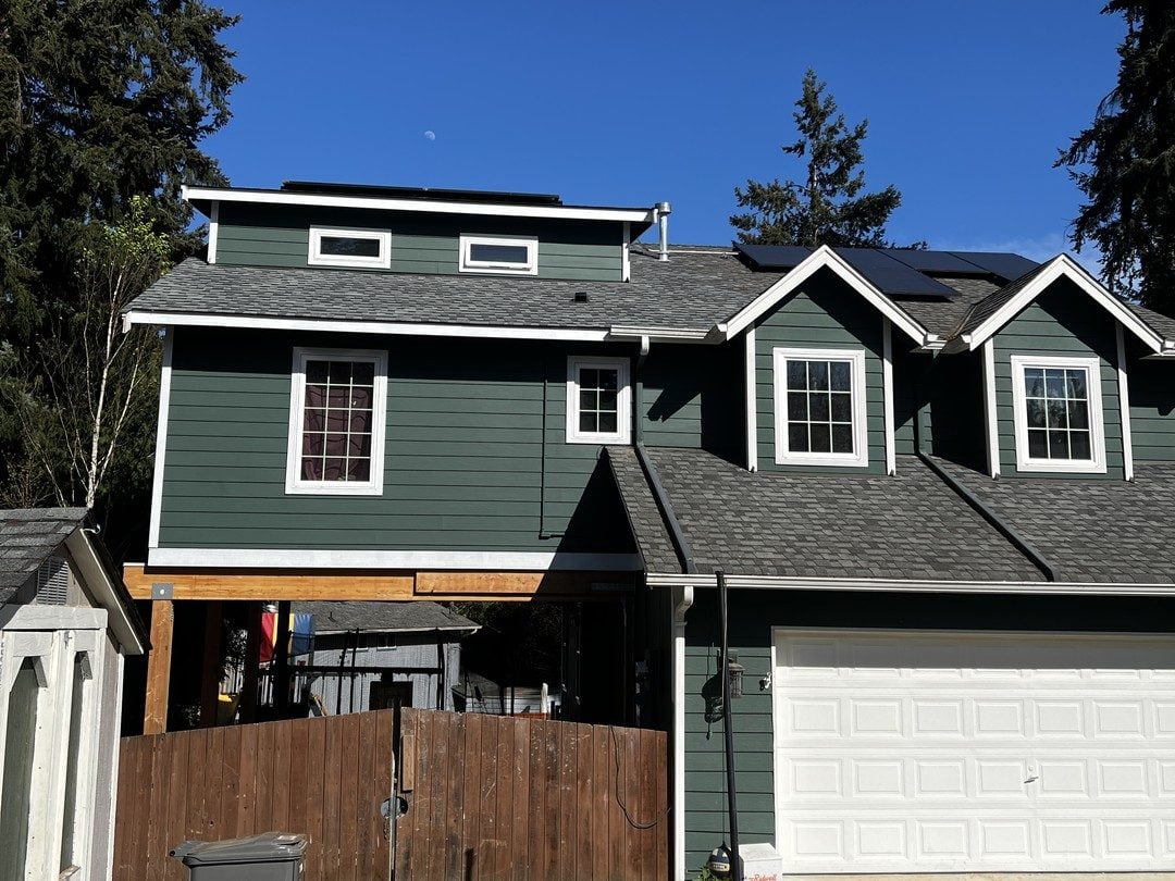 Two-story home in Lynnwood painted deep green with white trim
