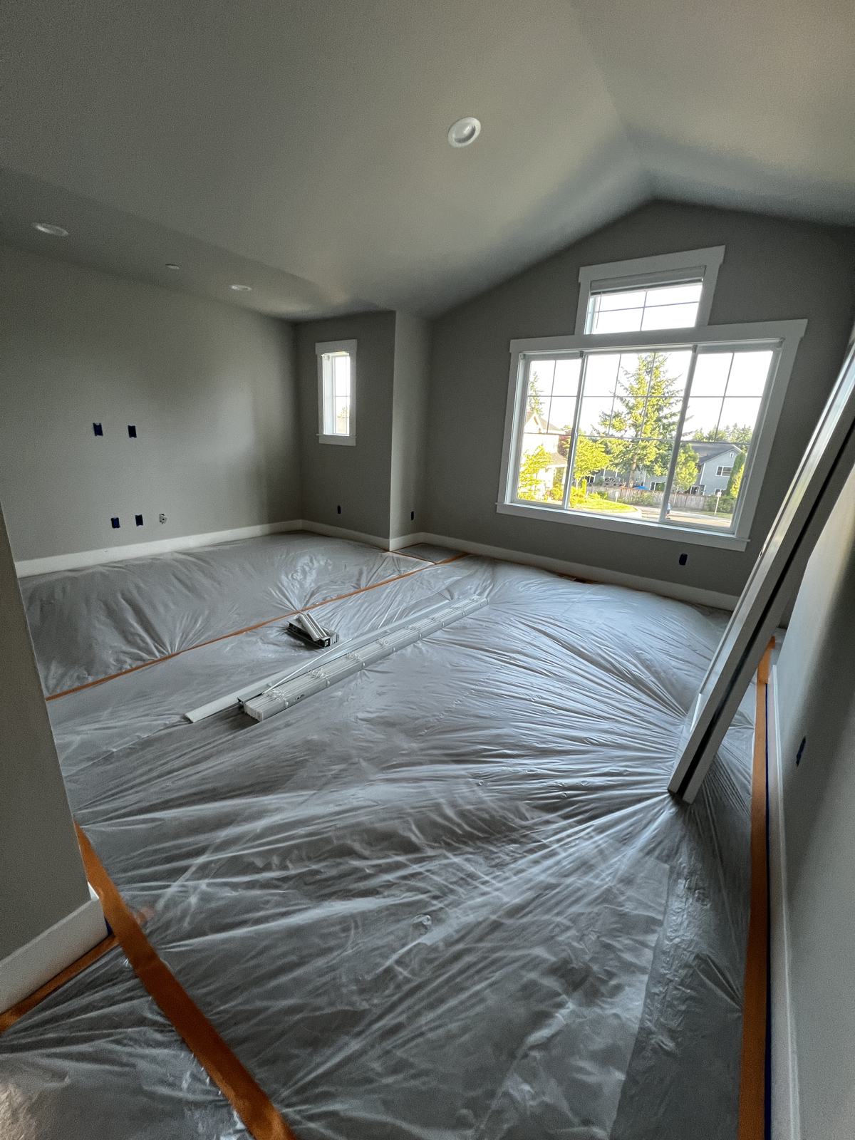 Woodinville bedroom with floors protected and edges taped before painting