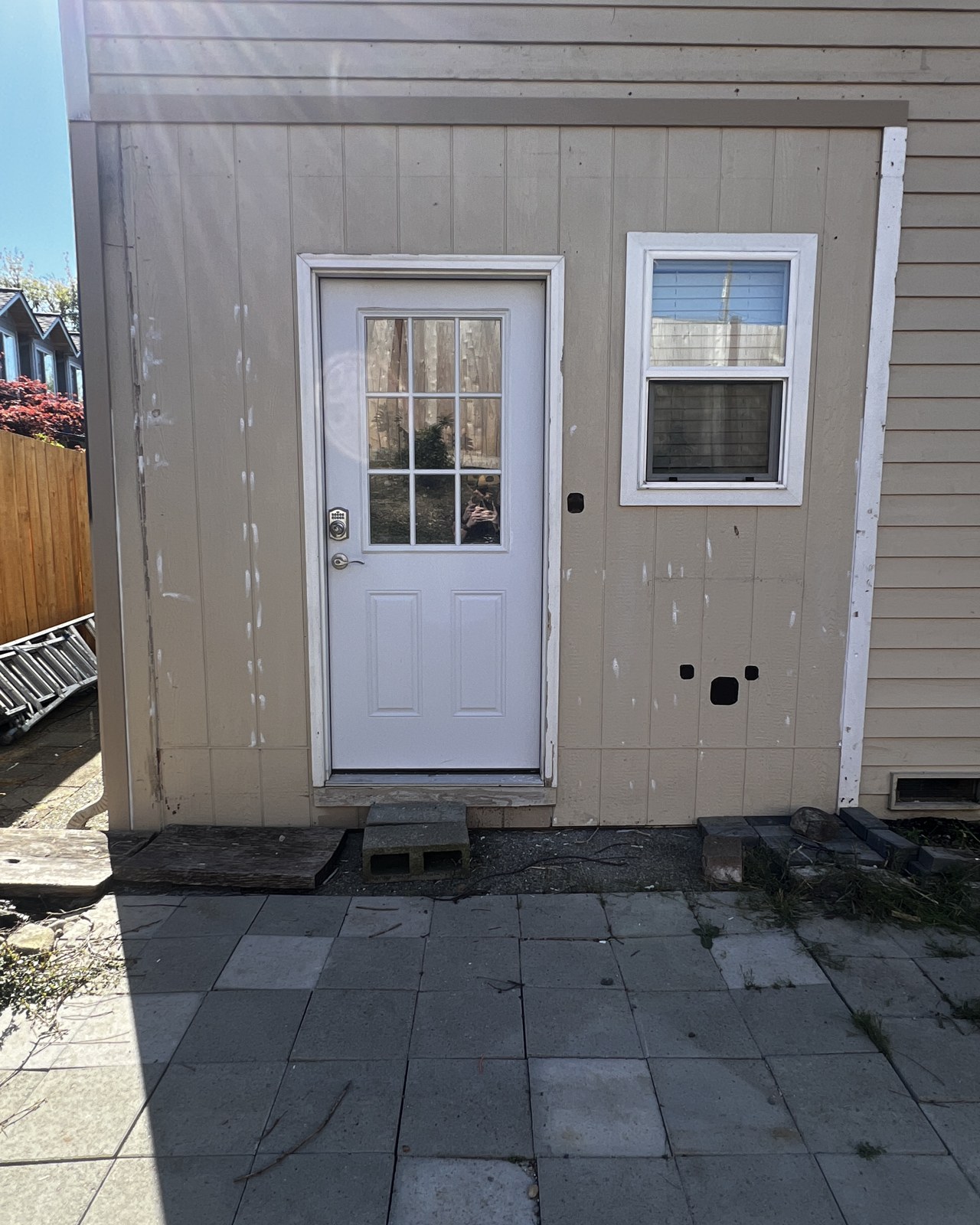 The same Mill Creek home's tan siding before the exterior repaint