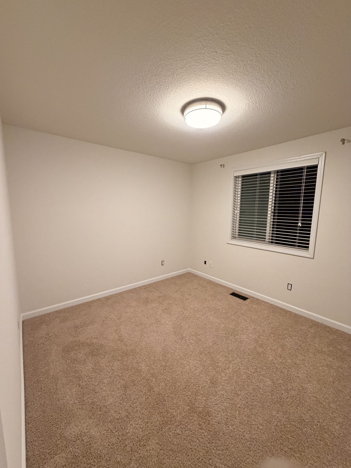 Clean, freshly painted empty bedroom ready for a new tenant