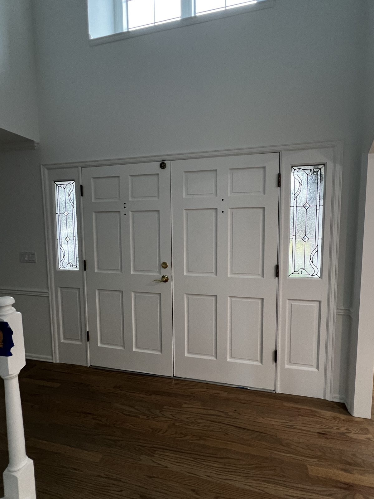 Two-story entry with freshly painted white doors and trim in Mill Creek