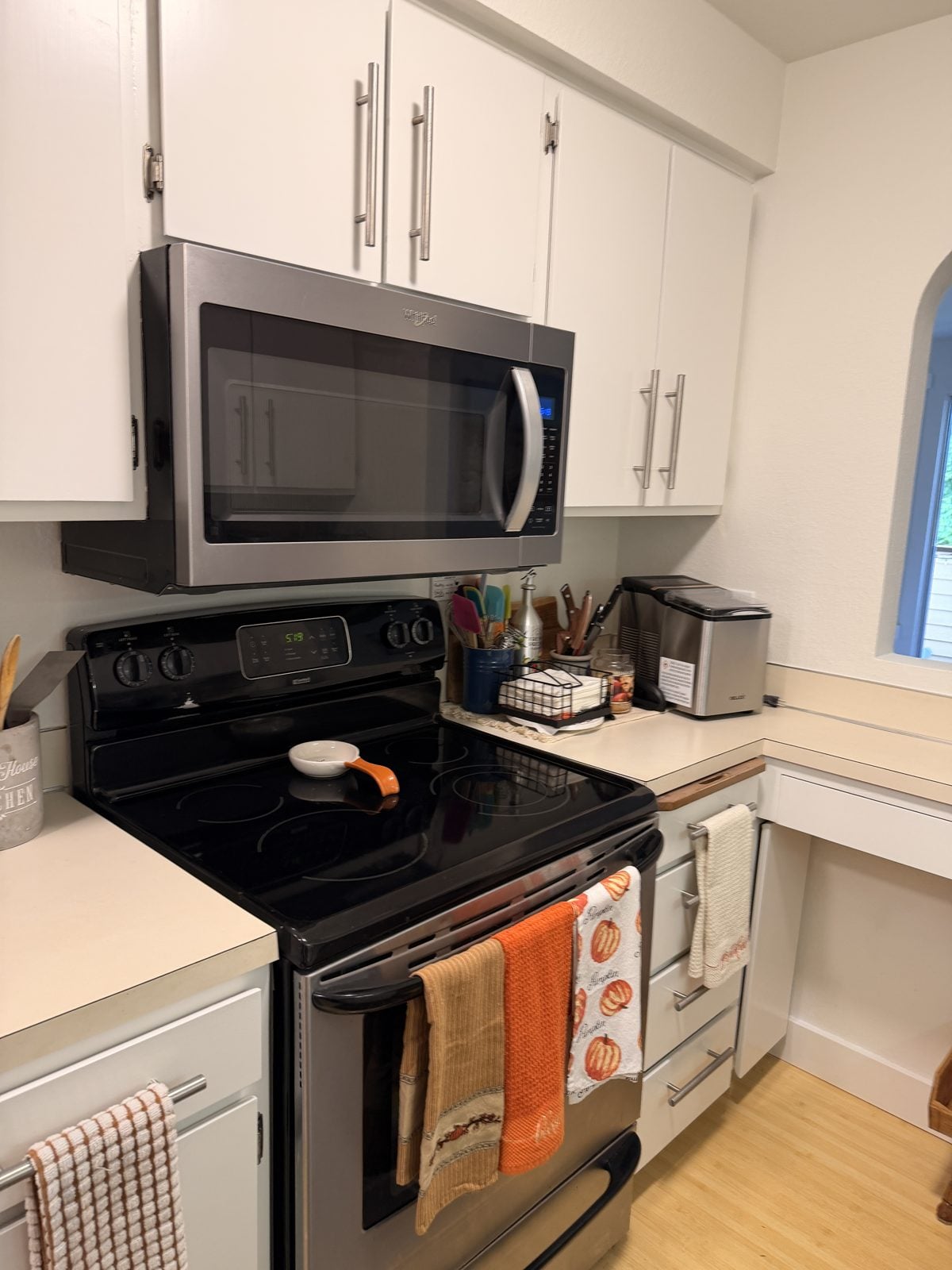 White painted cabinets around the range in an Edmonds condo kitchen