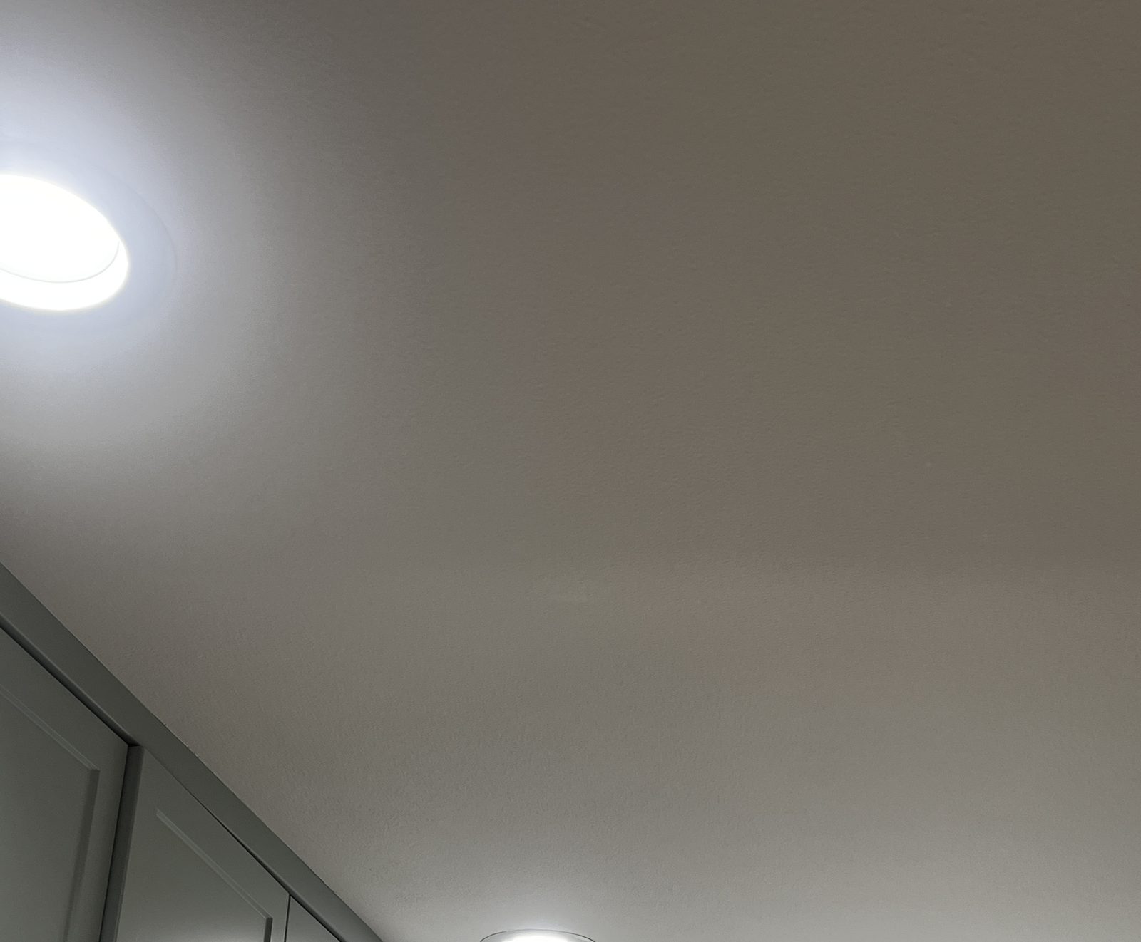 Smooth, freshly finished ceiling with recessed lights