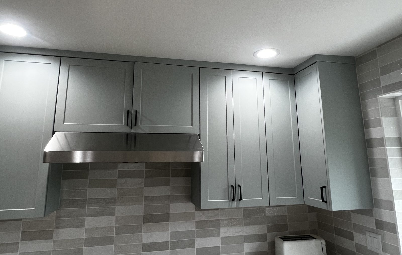 Kitchen cabinets painted a soft sage gray