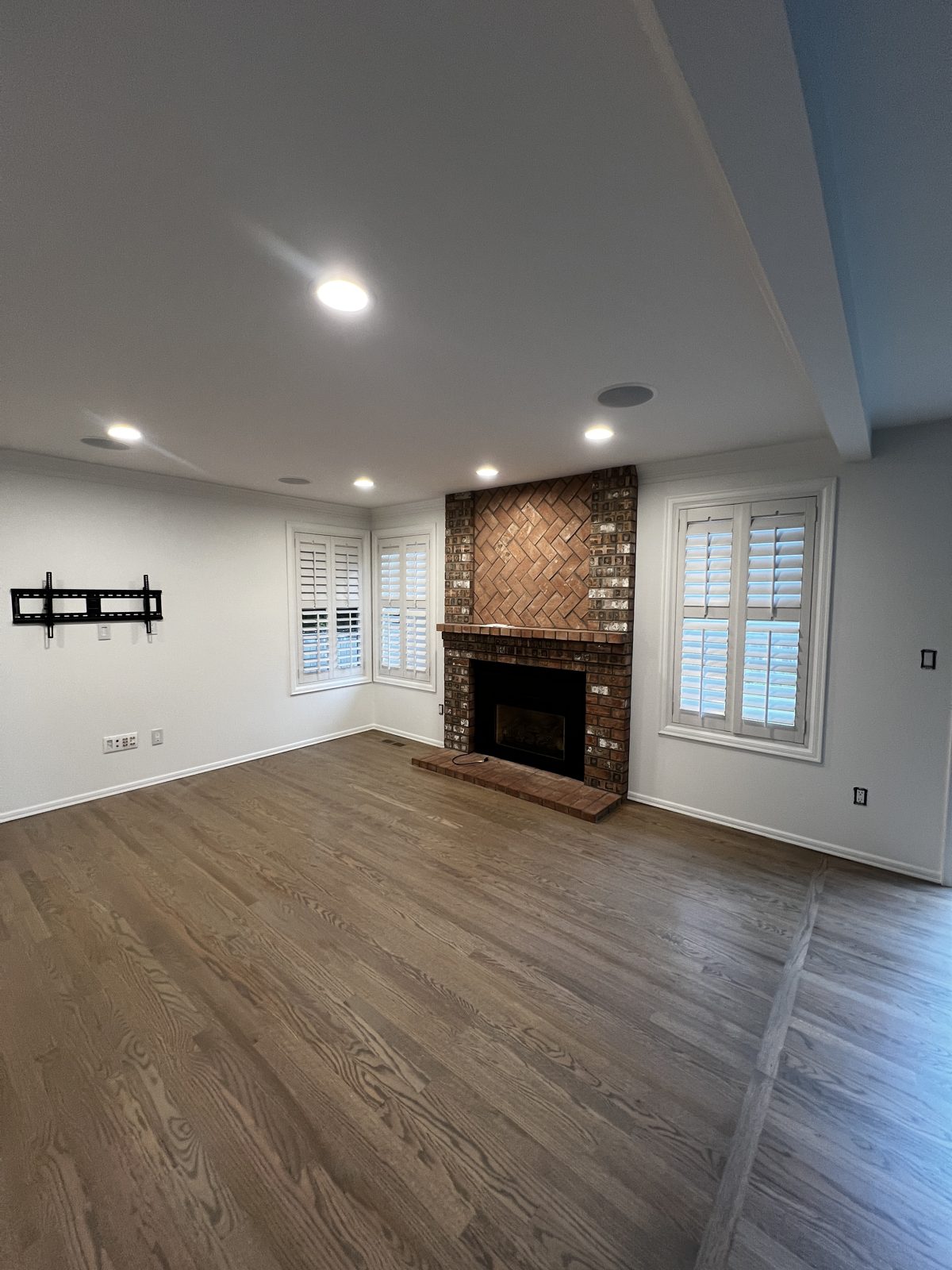 Freshly painted family room with a brick fireplace