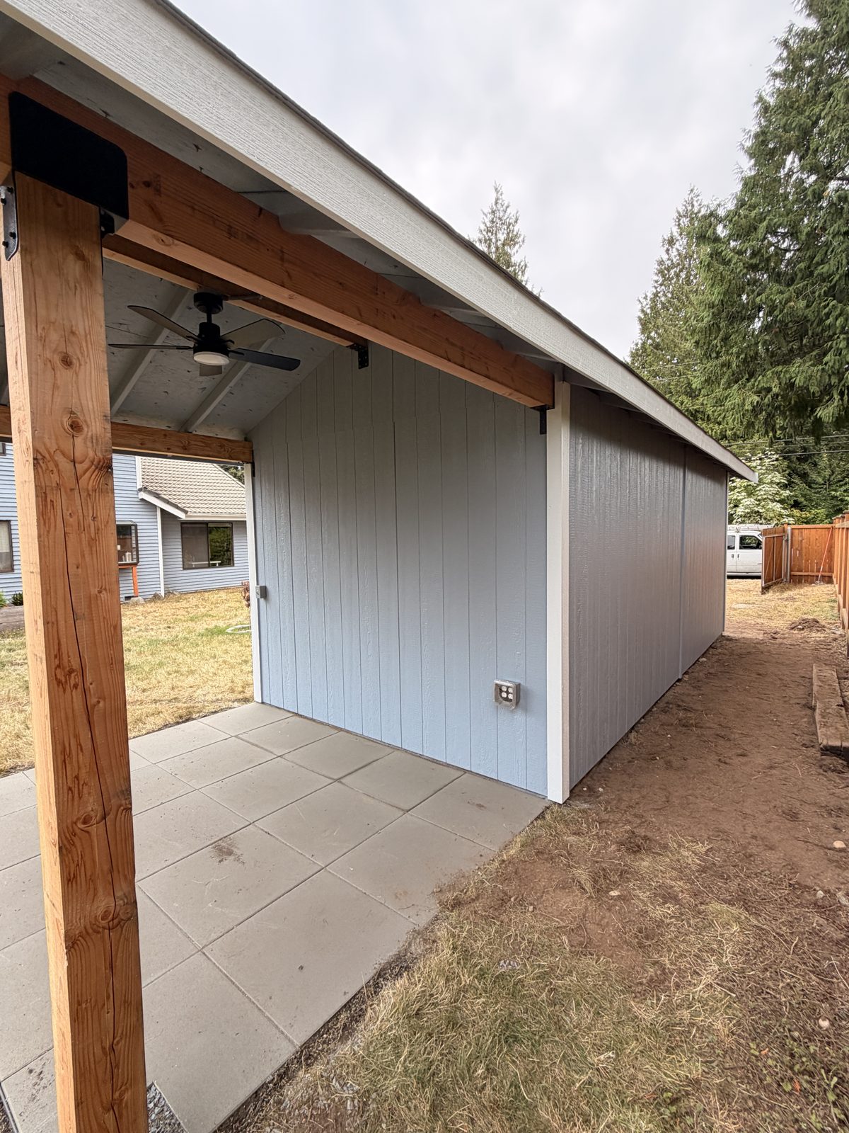 Side view of the Bothell ADU covered patio and blue-gray siding