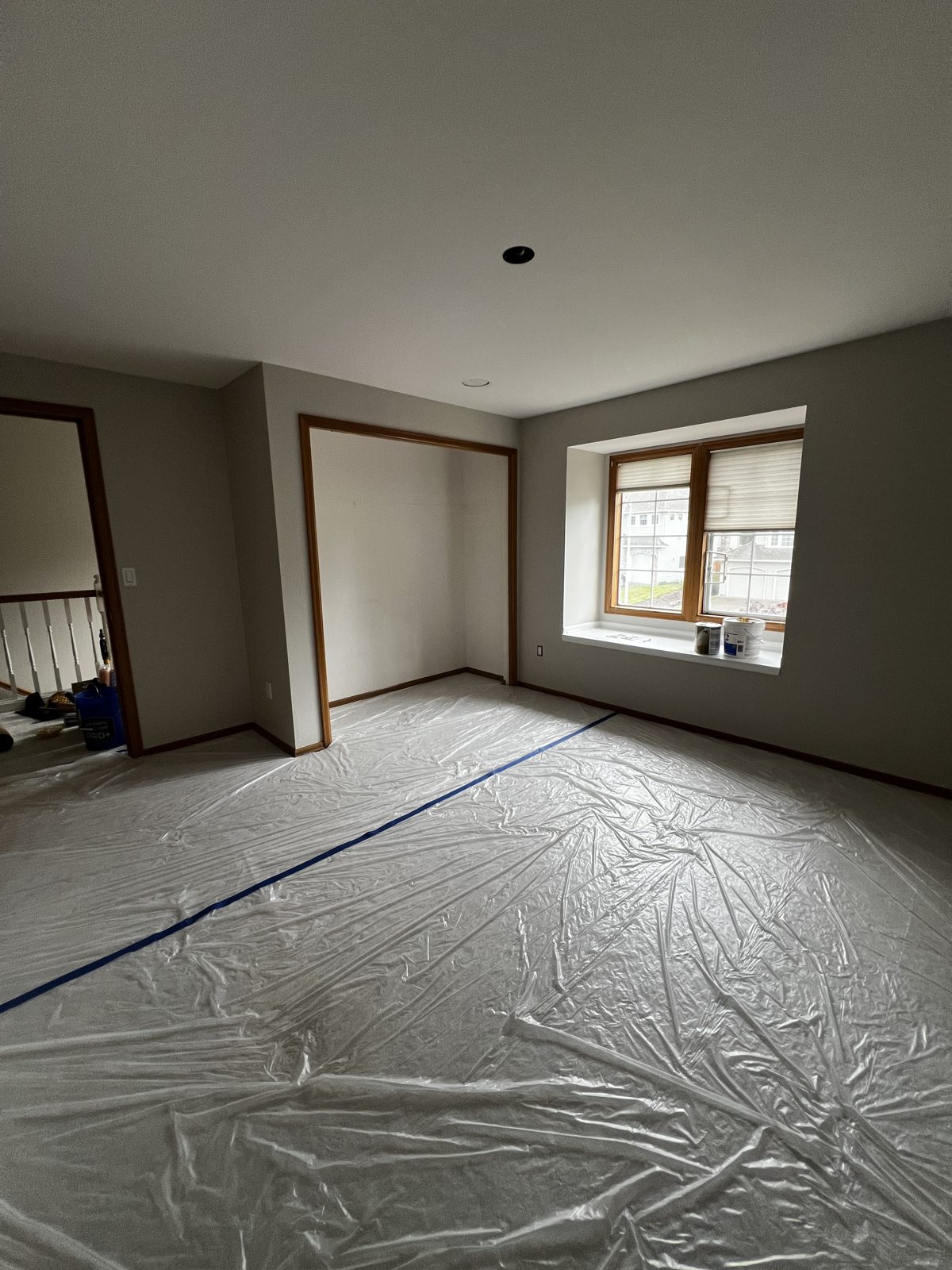 Floors fully covered with plastic and tape before interior painting
