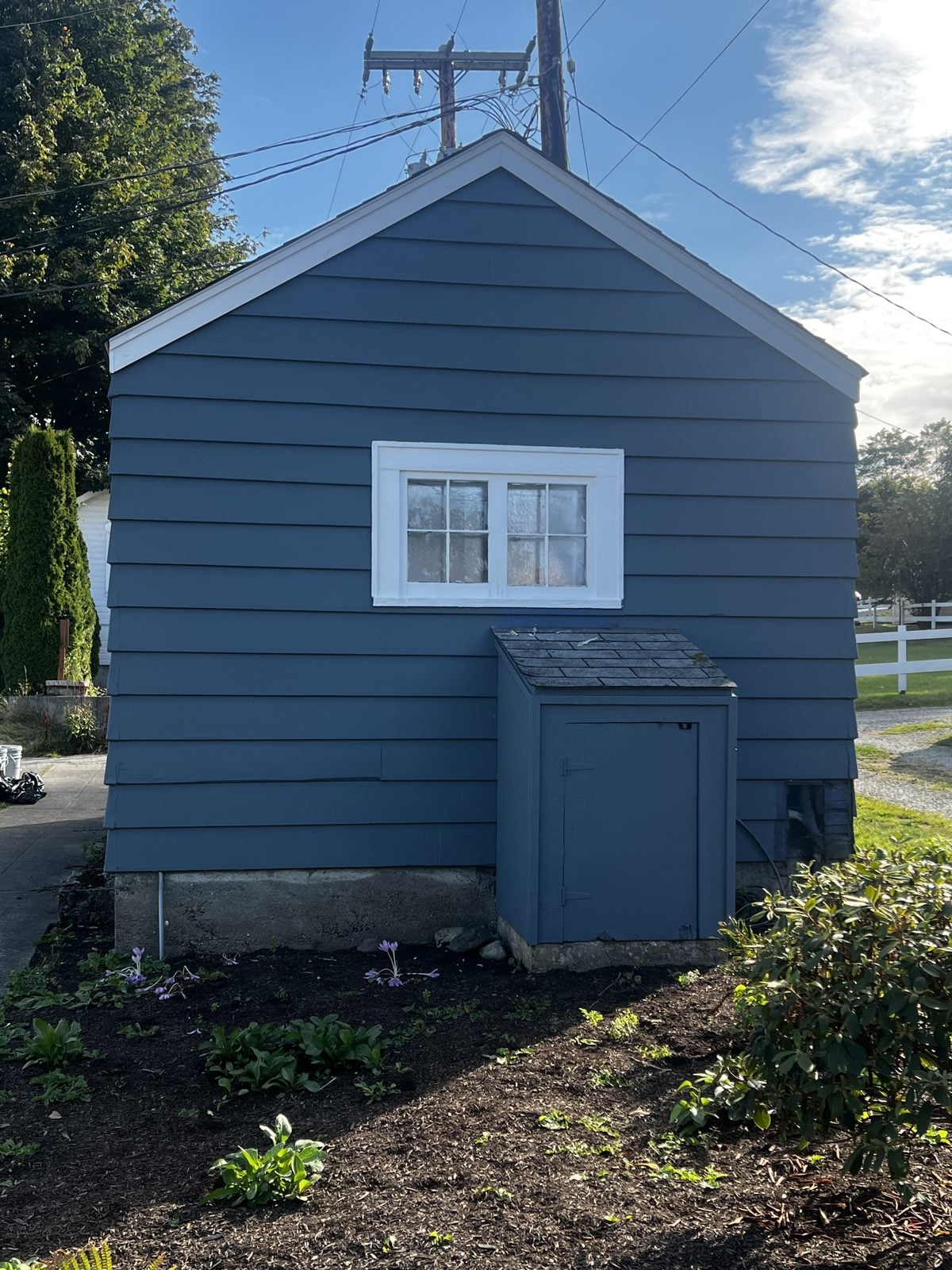 The same wall repainted in blue with white trim