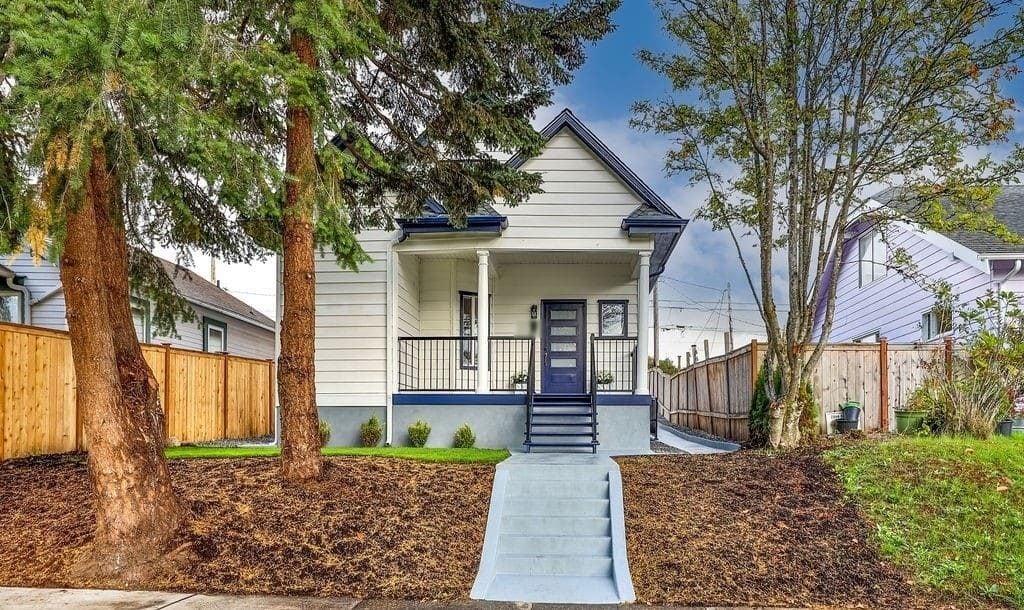 Exterior 2 Repaint After 8 a house with a tree and a fence