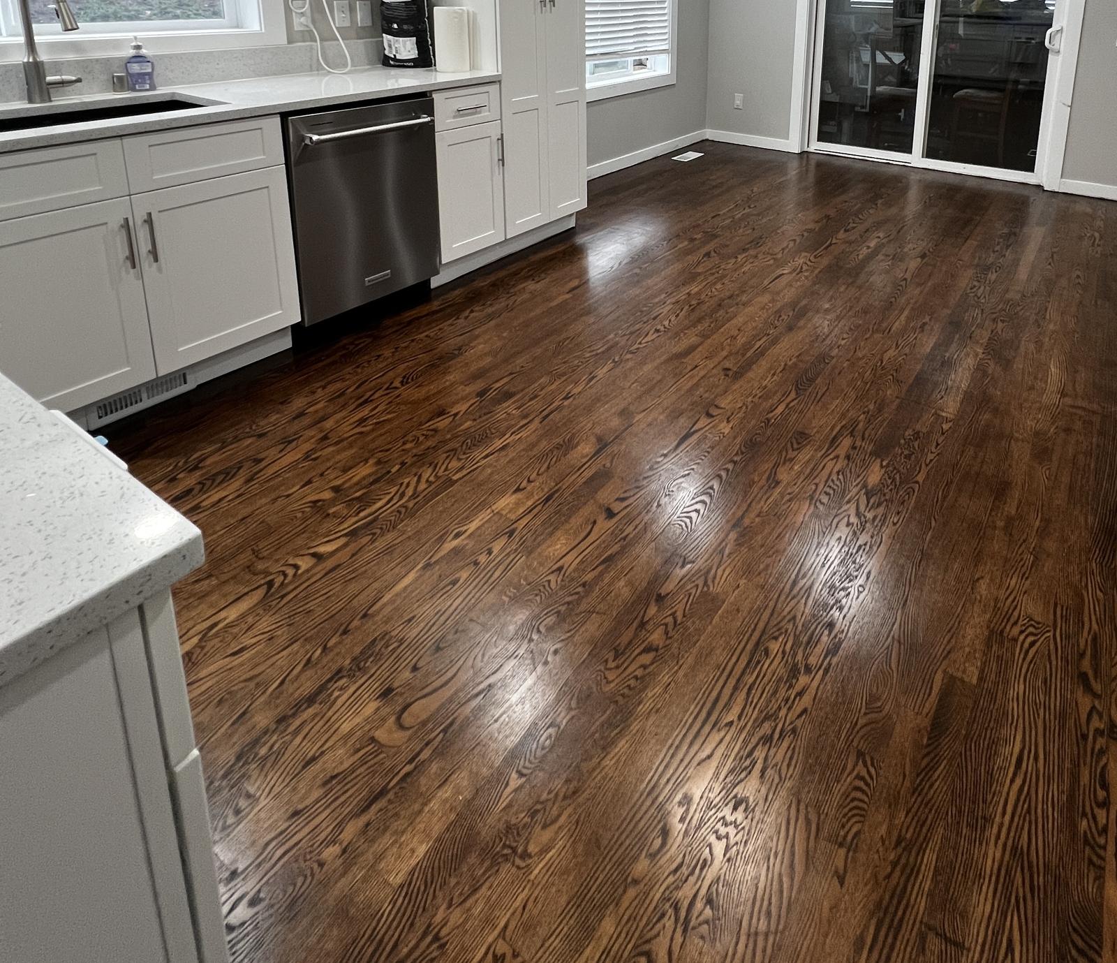 Hardwood kitchen floor sanded and refinished in a rich dark stain