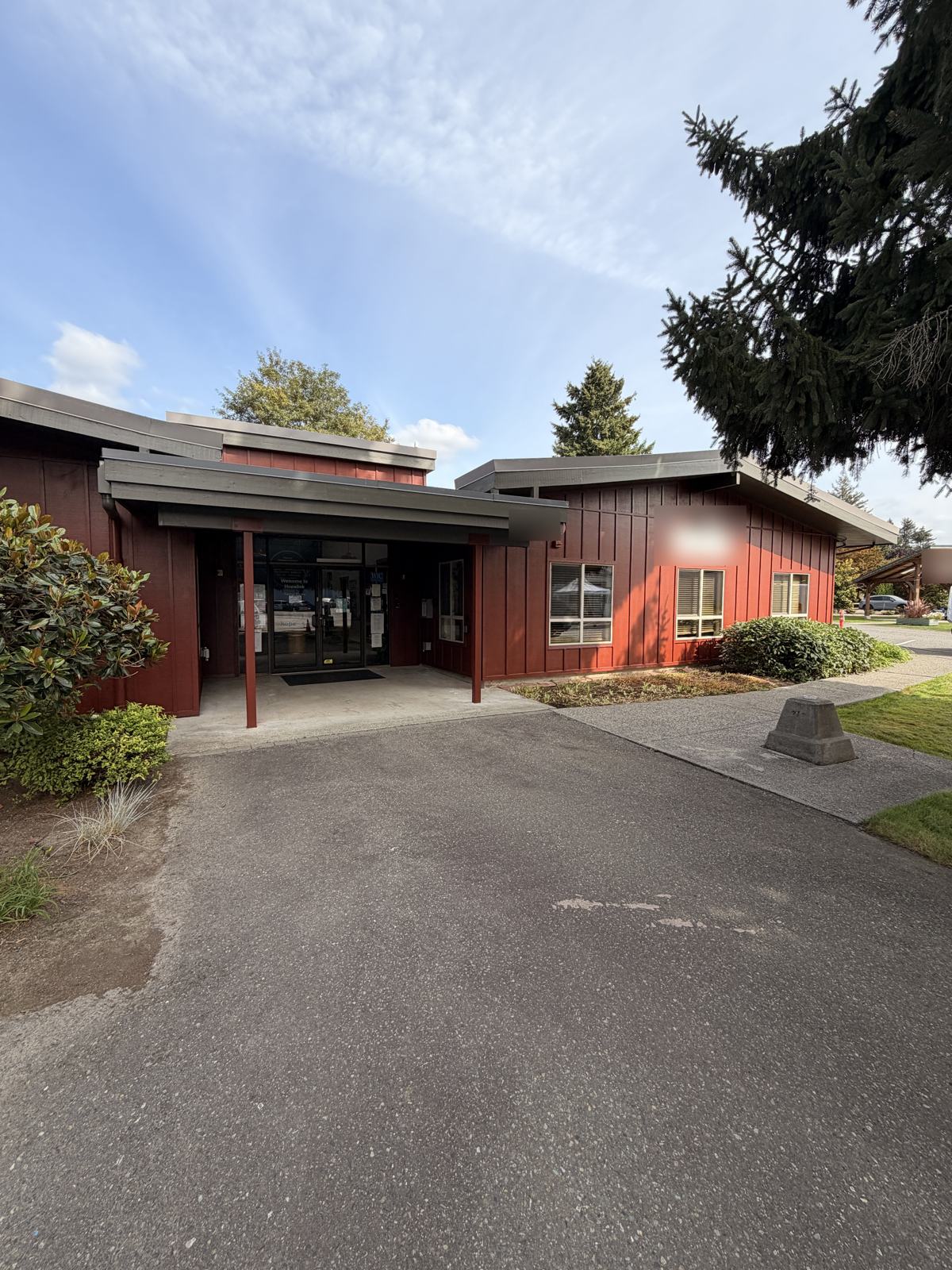 Red board and batten building entrance after commercial painting of the exterior