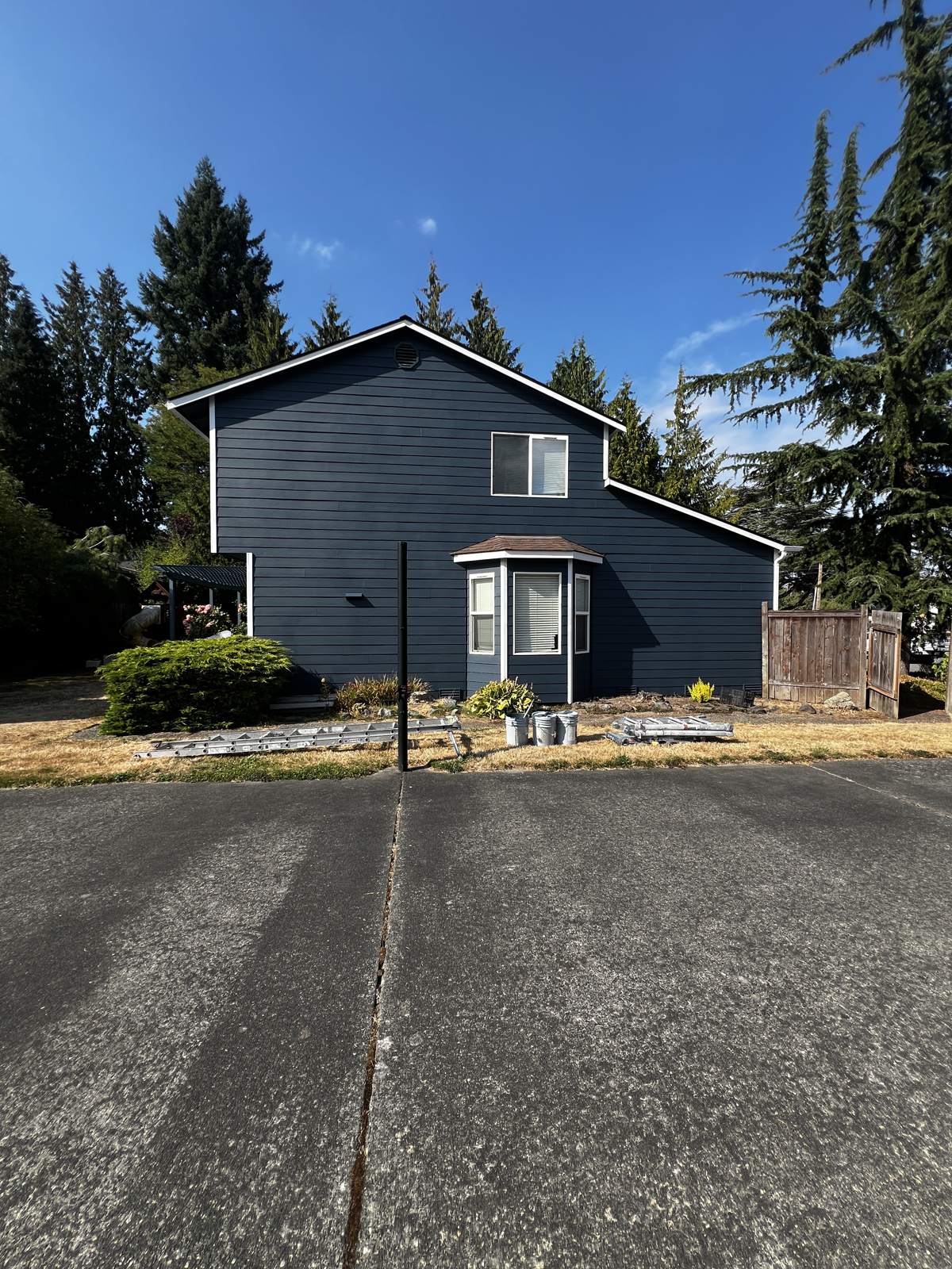 Two-story home repainted deep navy with white trim in Mill Creek